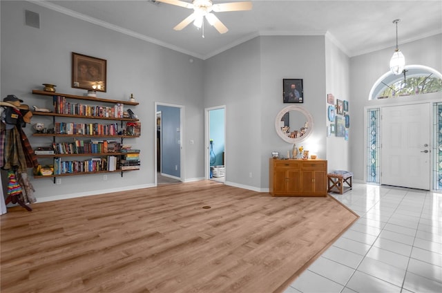 8015 N Tower Way, Citrus Springs, FL 34434 - entryway with a towering ceiling, a ceiling fan, crown molding, baseboards, and light tile patterned floors