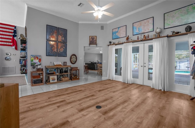 8015 N Tower Way, Citrus Springs, FL 34434 - living room with a towering ceiling, ceiling fan, crown molding, wood finished floors, and french doors