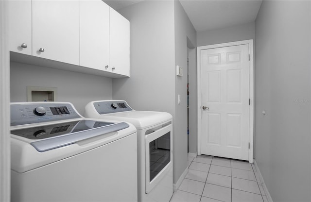 8015 N Tower Way, Citrus Springs, FL 34434 - washroom featuring washing machine and dryer, cabinet space, baseboards, and light tile patterned flooring