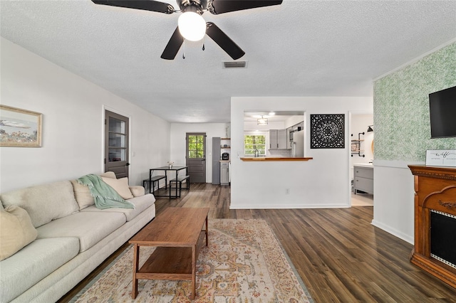 4601 SE 18th Ave, Ocala, FL 34480 - living room featuring wood finished floors, a ceiling fan, and a textured ceiling