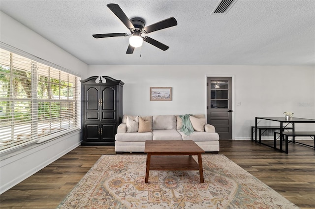 4601 SE 18th Ave, Ocala, FL 34480 - living room with a textured ceiling, ceiling fan, dark wood-style floors, and baseboards