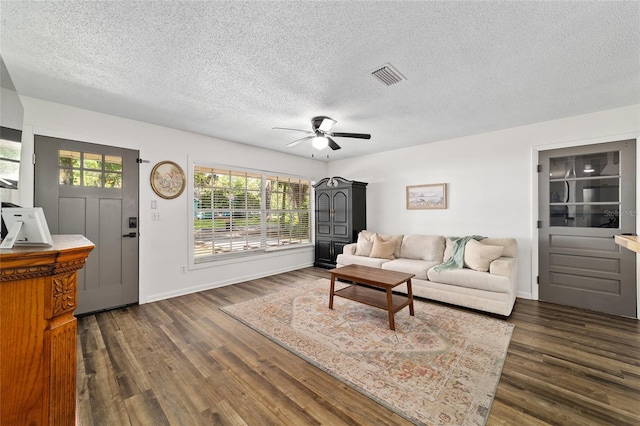 4601 SE 18th Ave, Ocala, FL 34480 - living area featuring a textured ceiling, dark wood-type flooring, a ceiling fan, and baseboards