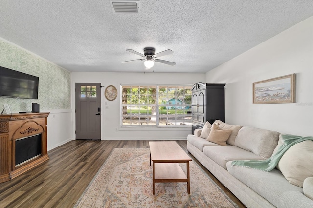 4601 SE 18th Ave, Ocala, FL 34480 - living area with dark wood-type flooring, ceiling fan, a textured ceiling, wainscoting, and wallpapered walls