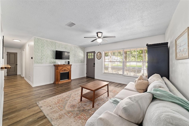 4601 SE 18th Ave, Ocala, FL 34480 - living room with ceiling fan, a textured ceiling, wood finished floors, wallpapered walls, and baseboards