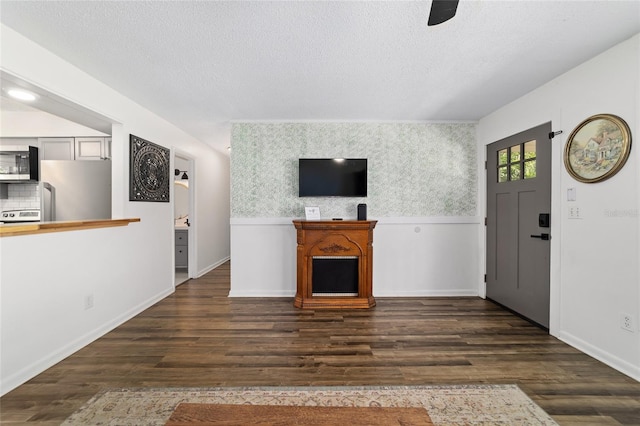 4601 SE 18th Ave, Ocala, FL 34480 - unfurnished living room featuring a textured ceiling, dark wood-type flooring, and baseboards