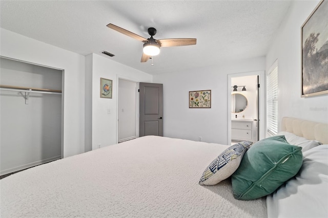 4601 SE 18th Ave, Ocala, FL 34480 - bedroom featuring a closet, ceiling fan, a textured ceiling, and connected bathroom