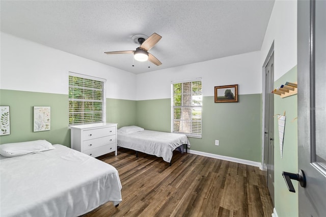 4601 SE 18th Ave, Ocala, FL 34480 - bedroom with a textured ceiling, dark wood-style floors, baseboards, and a ceiling fan