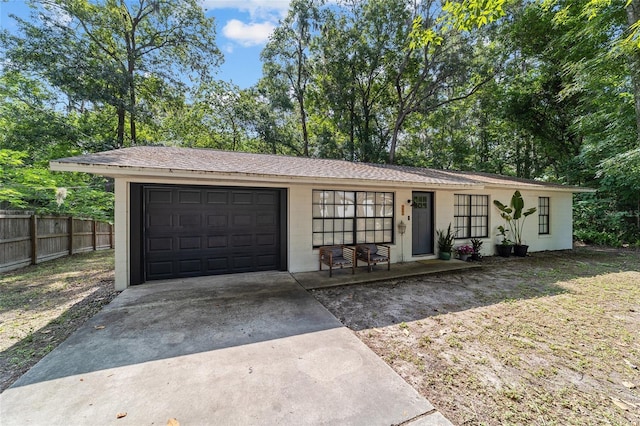 4601 SE 18th Ave, Ocala, FL 34480 - ranch-style home with concrete driveway, an attached garage, concrete block siding, and a porch