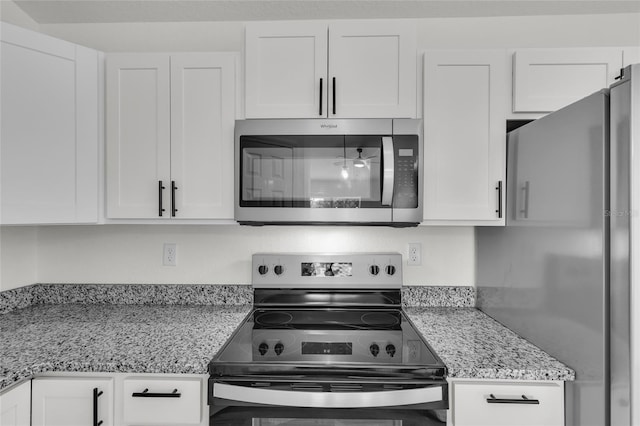 5701 NW 6th Pl, Ocala, FL 34482 - kitchen featuring stainless steel appliances, white cabinetry, and light stone countertops