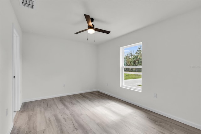 5701 NW 6th Pl, Ocala, FL 34482 - empty room with a ceiling fan, wood finished floors, and baseboards