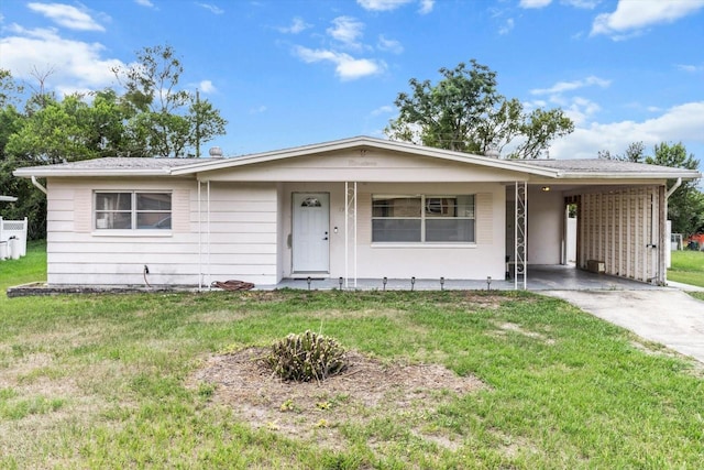 19 S Jefferson St, Beverly Hills, FL 34465 - single story home featuring concrete driveway, a front yard, an attached carport, and a porch