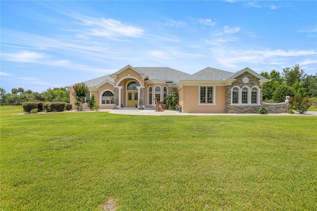 6573 S Magnolia Ave, Ocala, FL 34471 - mediterranean / spanish-style home featuring stone siding, a front yard, and stucco siding