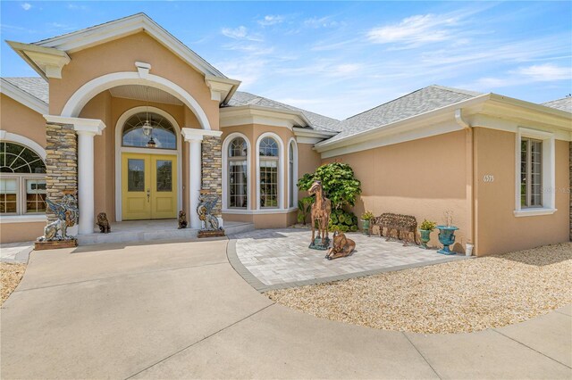 6573 S Magnolia Ave, Ocala, FL 34471 - entrance to property featuring stucco siding and roof with shingles