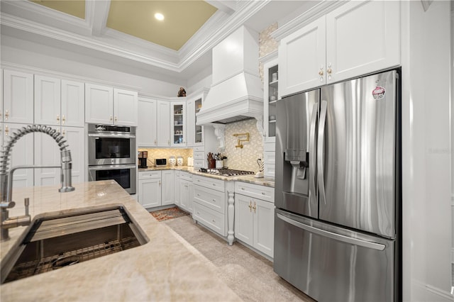 6573 S Magnolia Ave, Ocala, FL 34471 - kitchen with stainless steel appliances, premium range hood, a sink, white cabinets, and glass insert cabinets