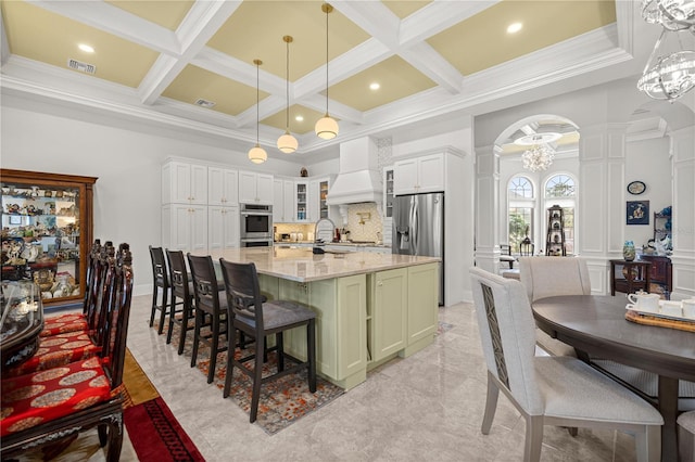 6573 S Magnolia Ave, Ocala, FL 34471 - kitchen featuring decorative columns, premium range hood, appliances with stainless steel finishes, arched walkways, and a high ceiling