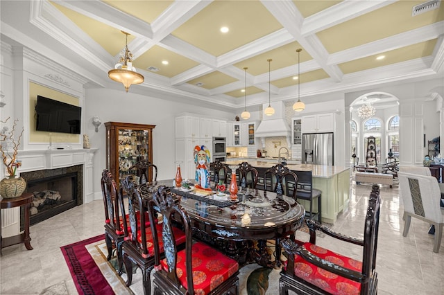 6573 S Magnolia Ave, Ocala, FL 34471 - dining space featuring coffered ceiling, decorative columns, arched walkways, a high end fireplace, and beamed ceiling
