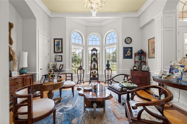 6573 S Magnolia Ave, Ocala, FL 34471 - living area featuring a decorative wall, wood finished floors, ornamental molding, a wainscoted wall, and a chandelier