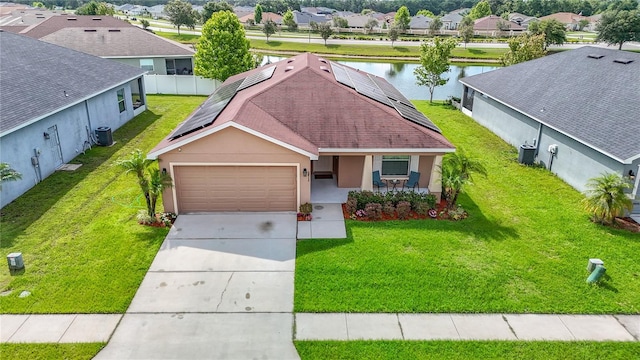 6812 Gideon Cir, Zephyrhills, FL 33541 - view of front facade with a residential view, a garage, stucco siding, a water view, and roof mounted solar panels