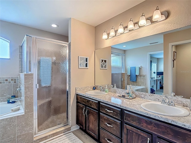 6812 Gideon Cir, Zephyrhills, FL 33541 - full bathroom featuring double vanity, a garden tub, and a stall shower