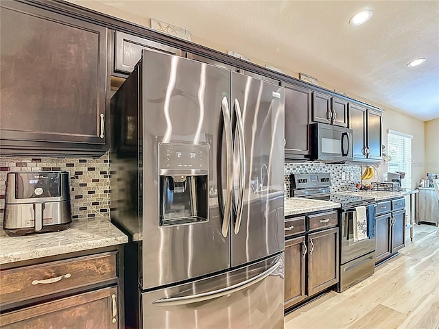 6812 Gideon Cir, Zephyrhills, FL 33541 - kitchen with black appliances, light wood-type flooring, backsplash, recessed lighting, and dark brown cabinetry