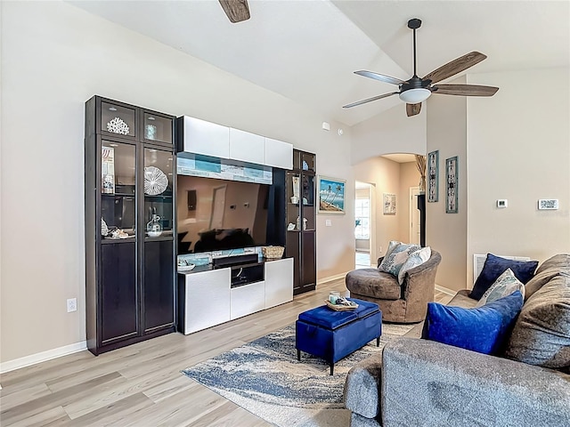 6812 Gideon Cir, Zephyrhills, FL 33541 - living room with ceiling fan, arched walkways, light wood-type flooring, baseboards, and high vaulted ceiling