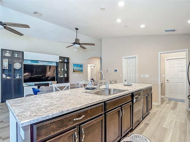6812 Gideon Cir, Zephyrhills, FL 33541 - kitchen featuring a ceiling fan, a sink, vaulted ceiling, arched walkways, and light wood finished floors