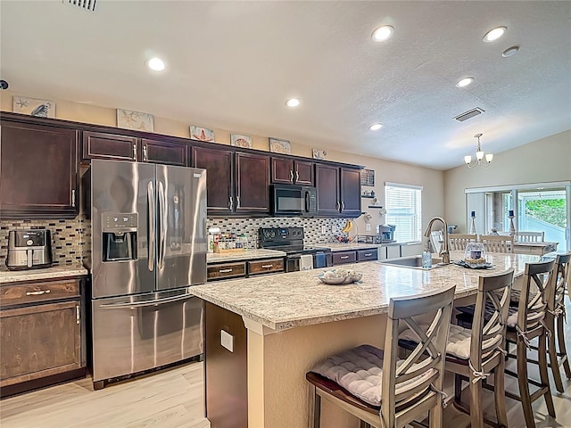 6812 Gideon Cir, Zephyrhills, FL 33541 - kitchen featuring black appliances, healthy amount of natural light, a sink, decorative backsplash, and recessed lighting
