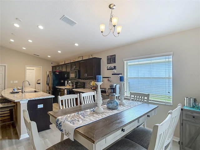 6812 Gideon Cir, Zephyrhills, FL 33541 - dining space featuring light wood finished floors, recessed lighting, a chandelier, vaulted ceiling, and baseboards