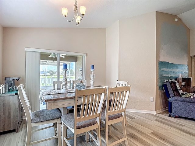 6812 Gideon Cir, Zephyrhills, FL 33541 - dining space with light wood finished floors, baseboards, vaulted ceiling, and a chandelier