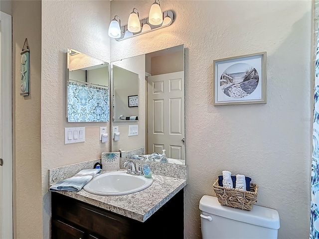 6812 Gideon Cir, Zephyrhills, FL 33541 - bathroom with vanity, toilet, a textured wall, and a chandelier