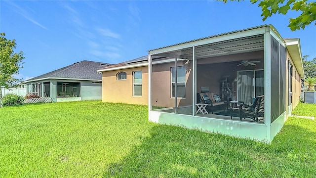 6812 Gideon Cir, Zephyrhills, FL 33541 - back of house featuring a sunroom, ceiling fan, and a lawn