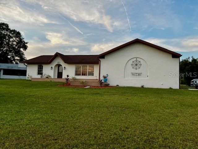 8770 SW 196th Terrace Rd, Dunnellon, FL 34432 - ranch-style home featuring a front lawn and stucco siding