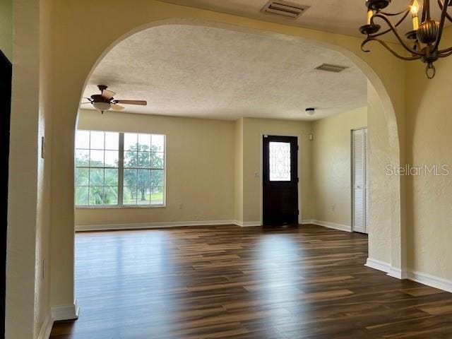 8770 SW 196th Terrace Rd, Dunnellon, FL 34432 - entryway featuring arched walkways, ceiling fan, dark wood-style floors, a chandelier, and baseboards