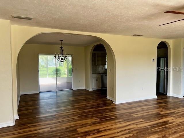 8770 SW 196th Terrace Rd, Dunnellon, FL 34432 - unfurnished room with a textured ceiling, dark wood-type flooring, ceiling fan, and arched walkways
