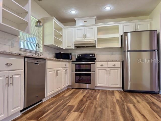 8770 SW 196th Terrace Rd, Dunnellon, FL 34432 - kitchen featuring open shelves, stainless steel appliances, under cabinet range hood, white cabinetry, and recessed lighting