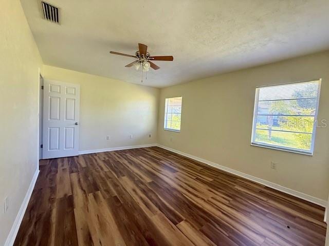 8770 SW 196th Terrace Rd, Dunnellon, FL 34432 - empty room with a ceiling fan, dark wood-type flooring, and baseboards