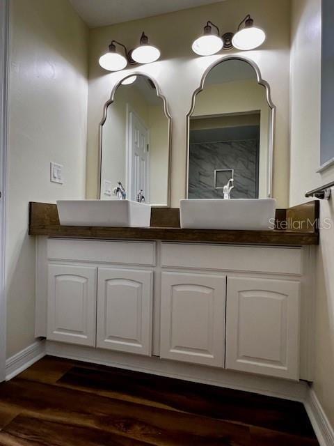 8770 SW 196th Terrace Rd, Dunnellon, FL 34432 - full bathroom featuring double vanity, baseboards, and wood finished floors