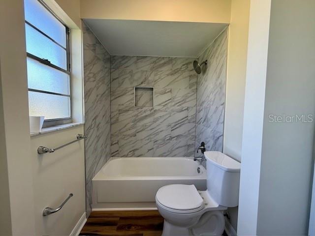 8770 SW 196th Terrace Rd, Dunnellon, FL 34432 - full bathroom featuring toilet, wood finished floors, shower / bathtub combination, and baseboards