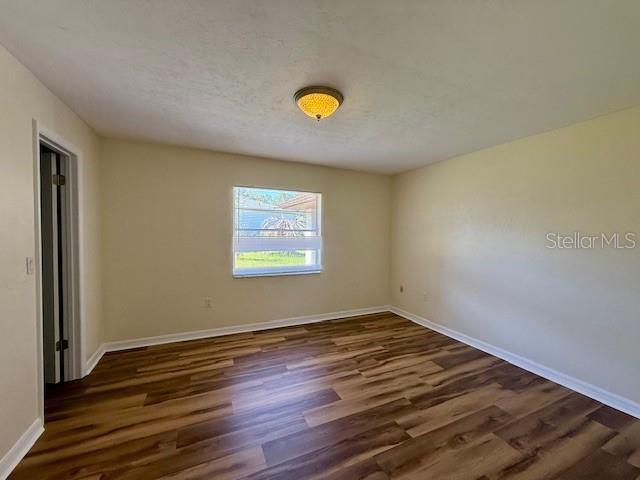 8770 SW 196th Terrace Rd, Dunnellon, FL 34432 - spare room with wood finished floors and baseboards