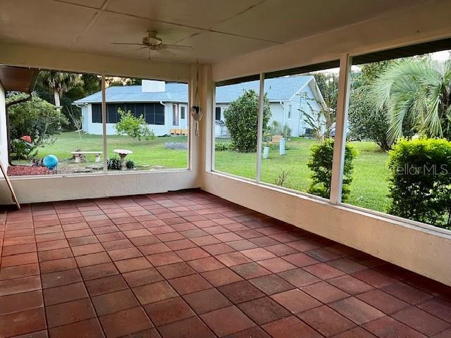8770 SW 196th Terrace Rd, Dunnellon, FL 34432 - unfurnished sunroom featuring tile patterned flooring and a ceiling fan