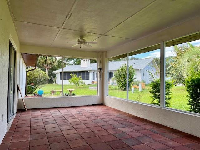 8770 SW 196th Terrace Rd, Dunnellon, FL 34432 - unfurnished sunroom with a ceiling fan and tile patterned floors