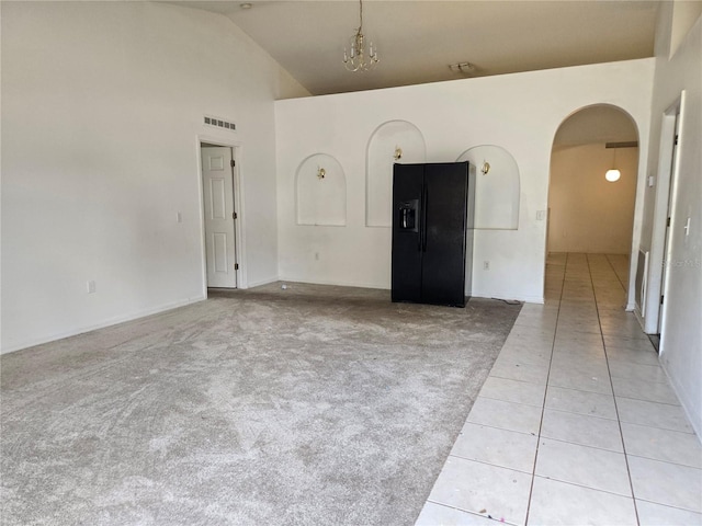 4460 SW 44th St, Ocala, FL 34474 - unfurnished room featuring arched walkways, light tile patterned floors, high vaulted ceiling, and light colored carpet