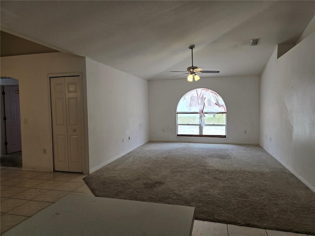 4460 SW 44th St, Ocala, FL 34474 - empty room featuring a ceiling fan, light carpet, arched walkways, baseboards, and lofted ceiling