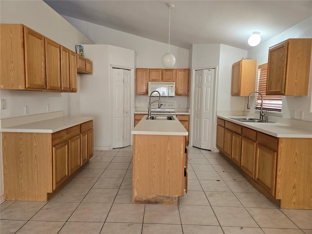 4460 SW 44th St, Ocala, FL 34474 - kitchen with white appliances, a sink, vaulted ceiling, an island with sink, and light countertops