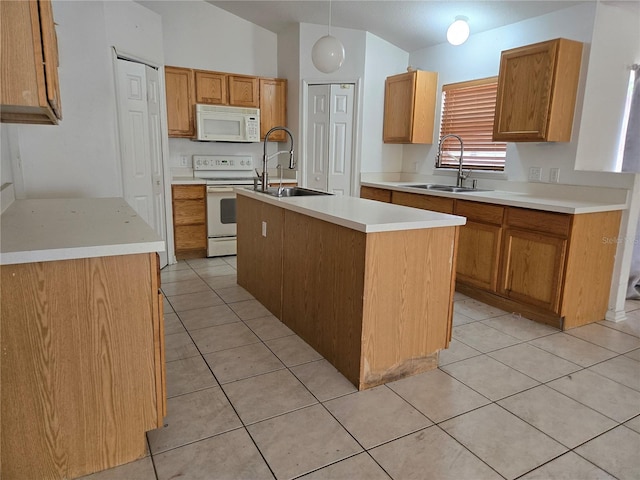 4460 SW 44th St, Ocala, FL 34474 - kitchen with white appliances, a sink, a center island with sink, and light tile patterned flooring