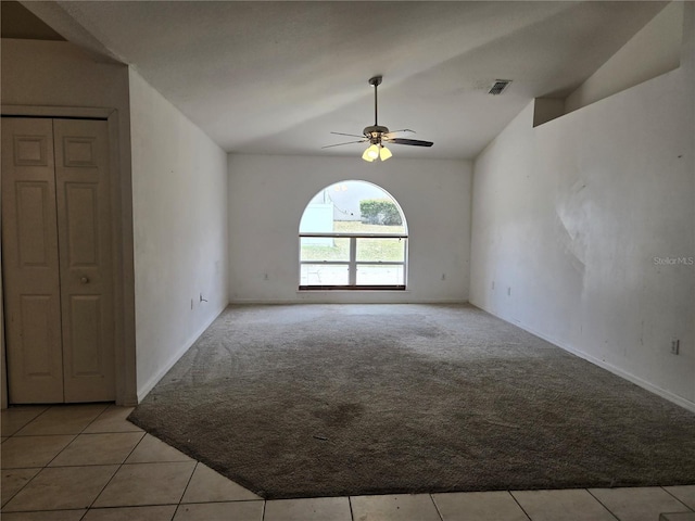4460 SW 44th St, Ocala, FL 34474 - spare room featuring light colored carpet, ceiling fan, light tile patterned flooring, and vaulted ceiling
