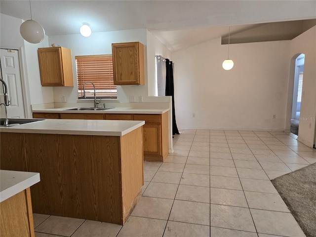 4460 SW 44th St, Ocala, FL 34474 - kitchen with a sink, arched walkways, light countertops, brown cabinetry, and pendant lighting