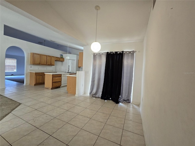 4460 SW 44th St, Ocala, FL 34474 - kitchen featuring dishwasher, light tile patterned floors, light countertops, arched walkways, and decorative light fixtures