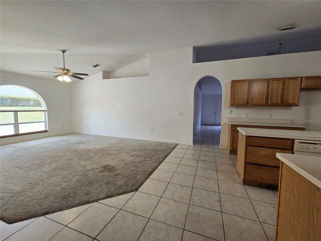 4460 SW 44th St, Ocala, FL 34474 - kitchen with arched walkways, vaulted ceiling, ceiling fan, brown cabinets, and light countertops