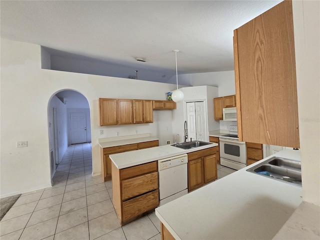 4460 SW 44th St, Ocala, FL 34474 - kitchen with white appliances, a sink, and brown cabinets
